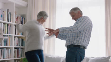 Glückliches-Altes-Paar,-Das-Zu-Hause-Tanzt-Und-Den-Ruhestandsjubiläum-Feiert,-Spaß-Beim-Tanzen-Hat-Und-Die-Meilensteinfeier-Der-Beziehung-Genießt-4k
