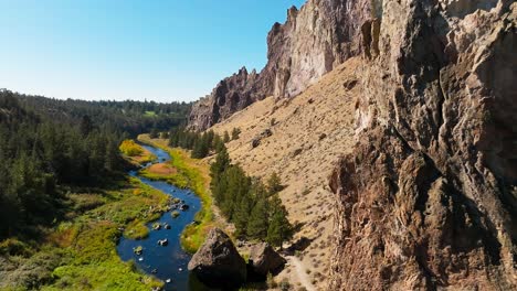 river running through smith rock state park, drone push in, oregon