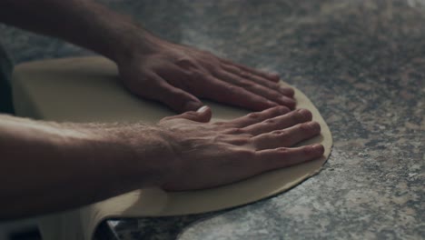 anonymous chef stretching dough for pastry