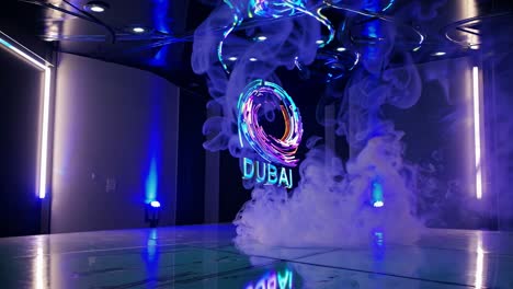 colorful holographic dubai logo illuminating swirling smoke in a futuristic environment, creating a captivating and immersive visual experience filled with vibrant energy and dynamic motion