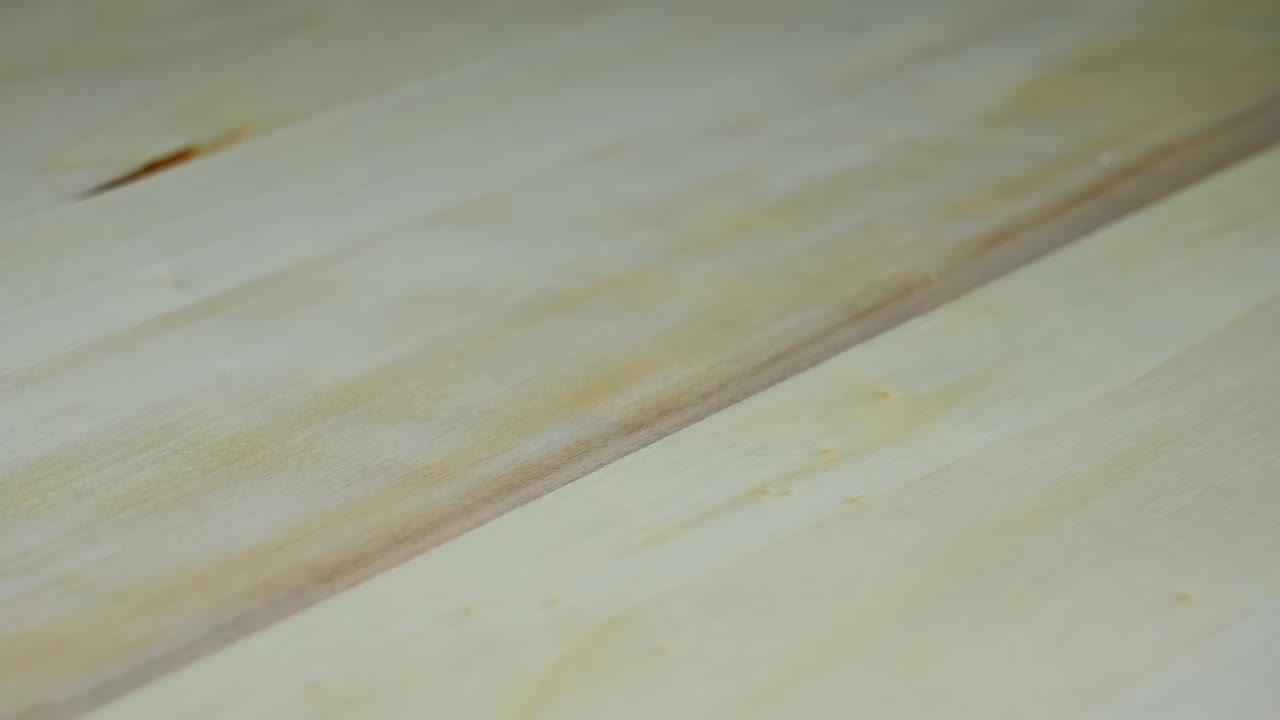 Multicolored heart shaped marshmallow falling on a wooden table from the left side of the frame. Close up. Valentines day snacks. Slow motion