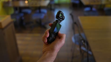 hand swiping on screen of dji osmo pocket 3 stabilized handheld mobile camera