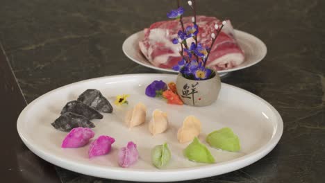 traditional chinese food - dumplings served on white plate with decorative flowers