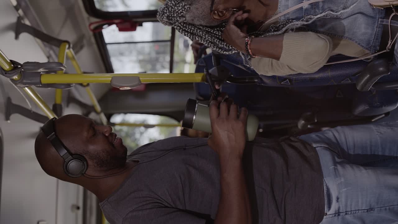 People traveling and using personal devices on a public bus