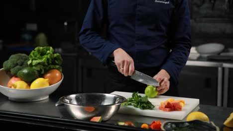 chef preparing a fresh fruit and vegetable salad