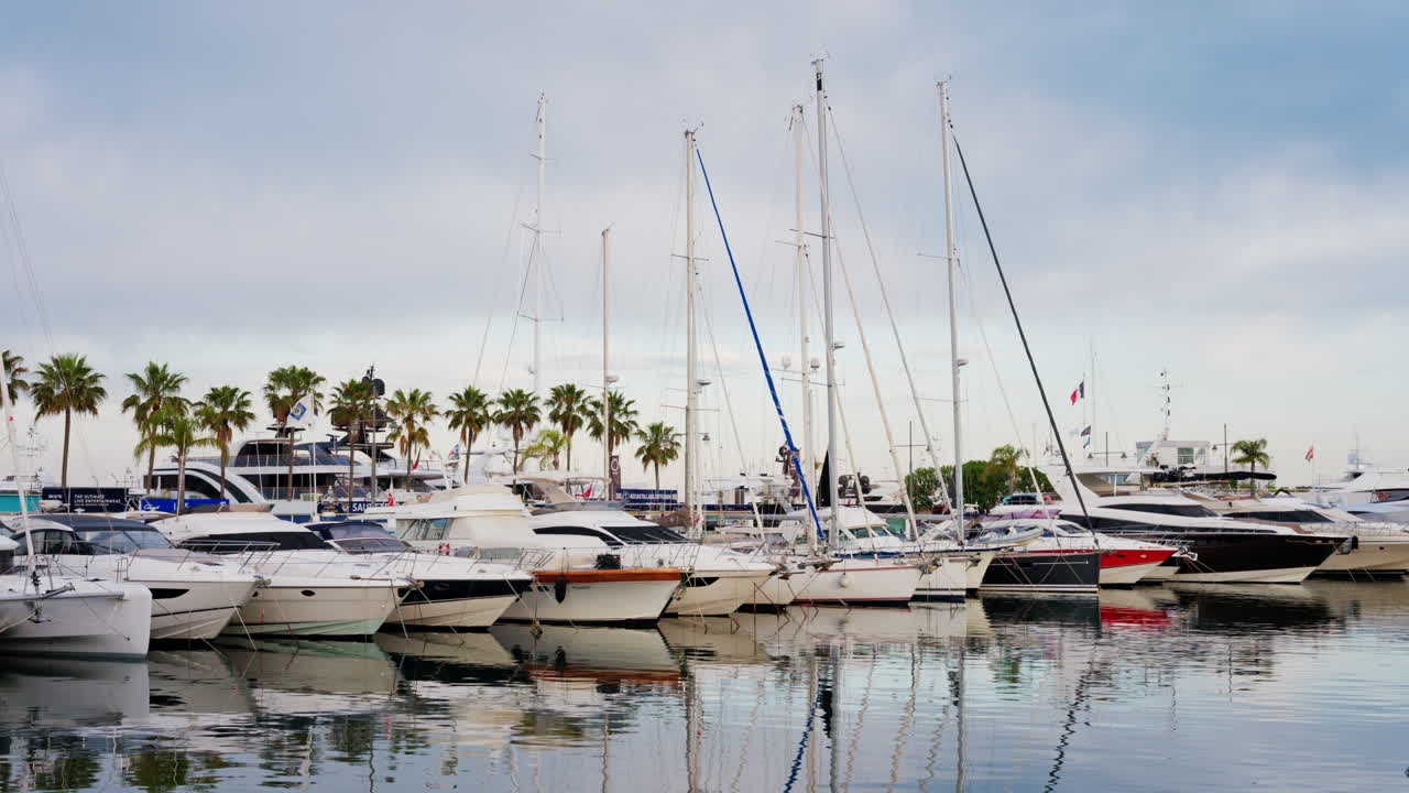 Antibes, France - May 23, 2025: Multiple white boats docked in the Port Vauban on a cloudy day