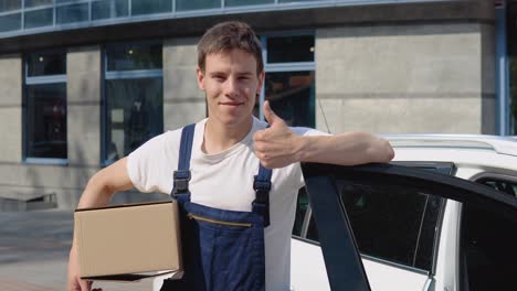 moving and delivery of manufactured goods. the driver fills in the cargo documents and looks into the camera. an employee holds a box in his hands and stands next to a car filled with parcels