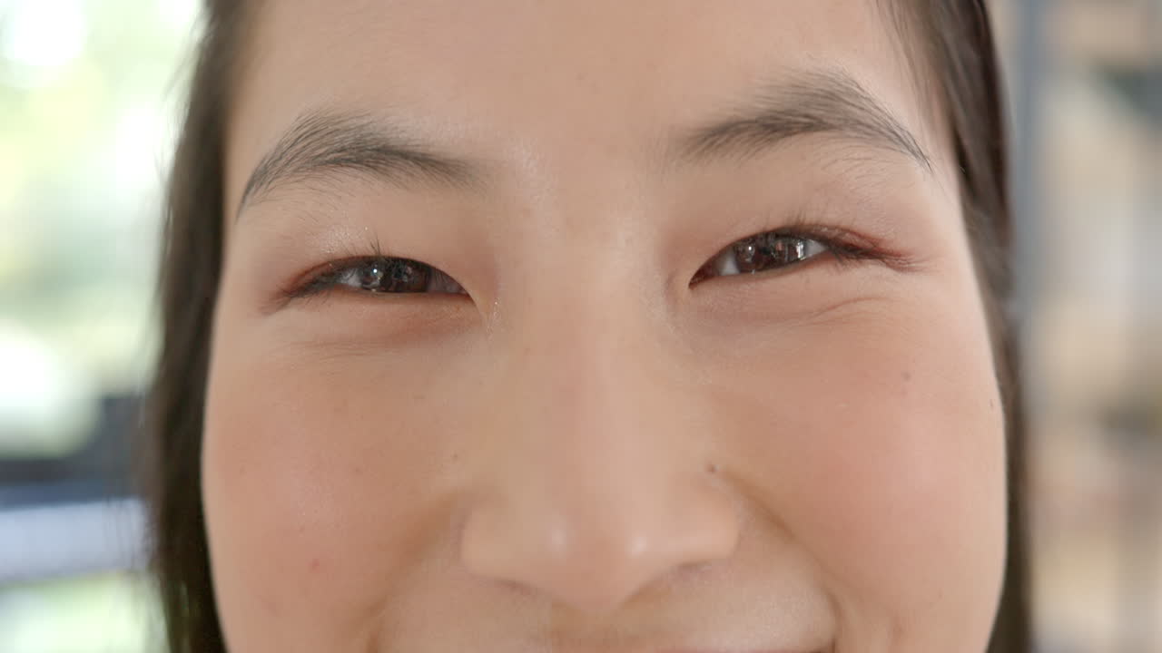 Smiling asian woman close-up, showing happiness and positive emotions