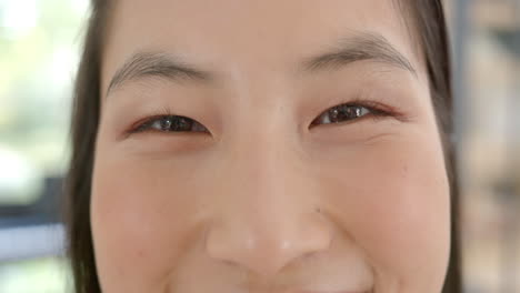 smiling asian woman close-up, showing happiness and positive emotions