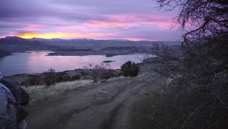 female hiker on roys peak trail at sunset in new zealand