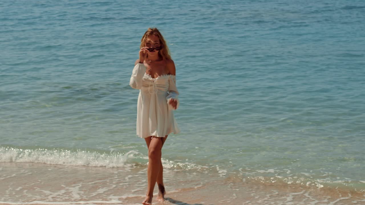 Woman enjoying the beach in a white dress