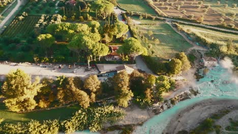 Cascate-del-Mulino,-Soothing-Natural-Hot-Springs-Bath,-Saturnia,-Tuscany,-Italy,-Europe,-Drone-view-traveling-left