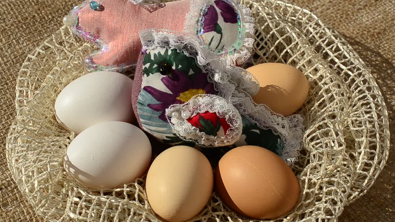 Eggs in a basket against a sacking. Easter still life