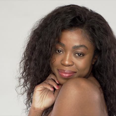 pleased black woman touching chin
