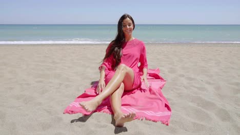 pretty young woman sunbathing in a pink tunic