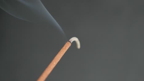 close-up of fragrant smoke spreading from burned incense stick 4k 2160p 30fps ultrahd footage - aromatic biotic material burning for meditation purpose 3840x2160 uhd video