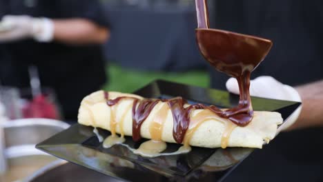 Chef-Pouring-Chocolate-Syrup-On-Top-Of-Freshly-Baked-Scone