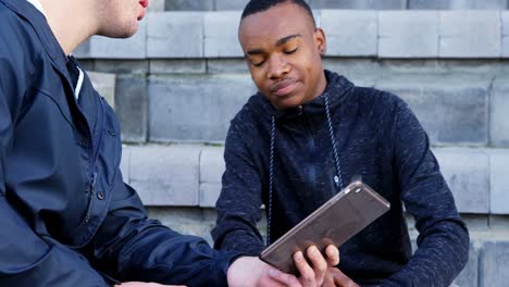 Two-disabled-athletics-discussing-over-digital-tablet-4k