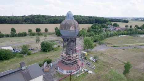 Aerial-point-of-interest,-historical-Germany-Ilsede-Water-Tower-during-restauration