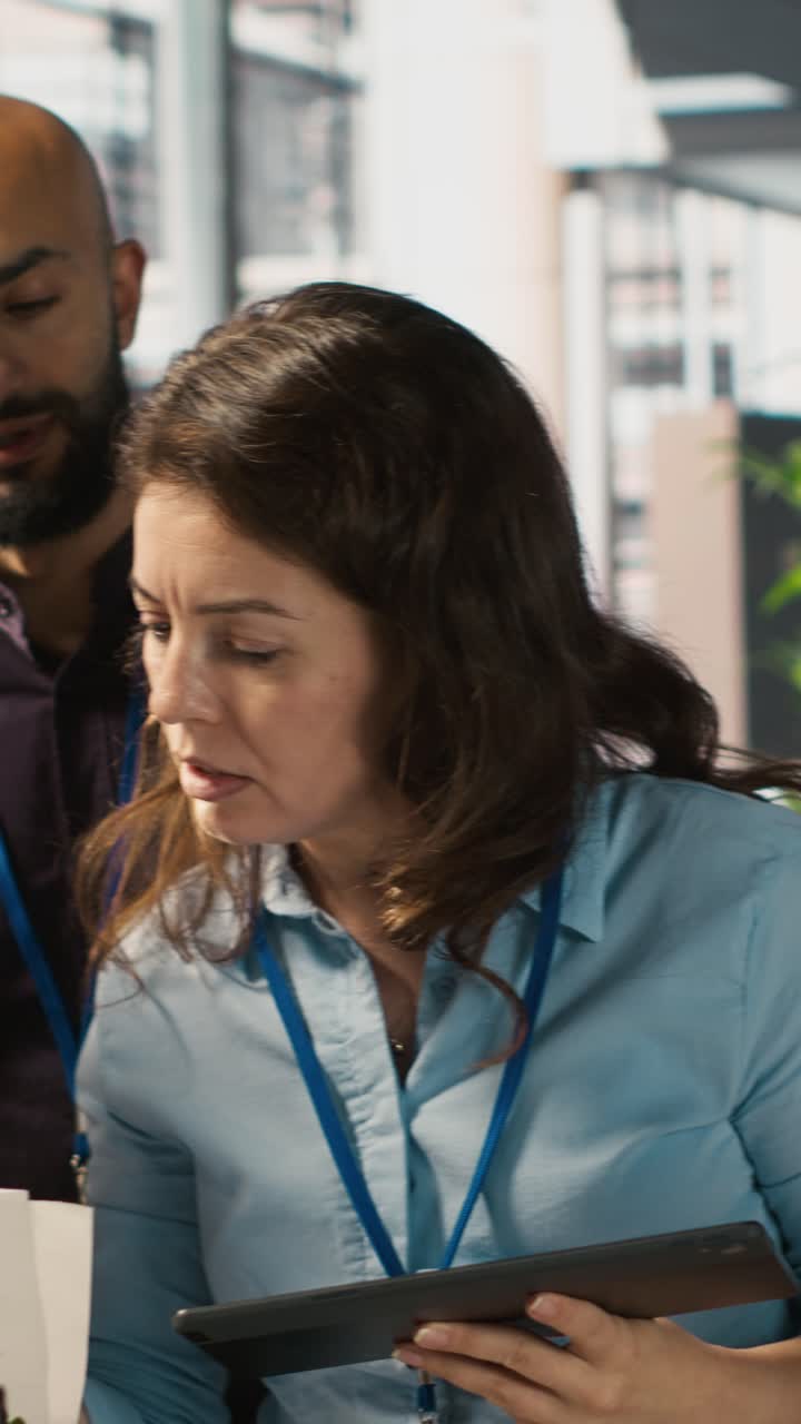 Vertical video Employees in office working together on finishing project