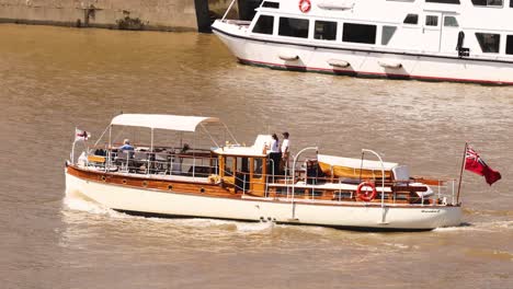 a boat cruising on the thames river