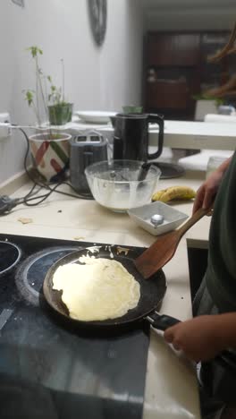 child cooking pancakes
