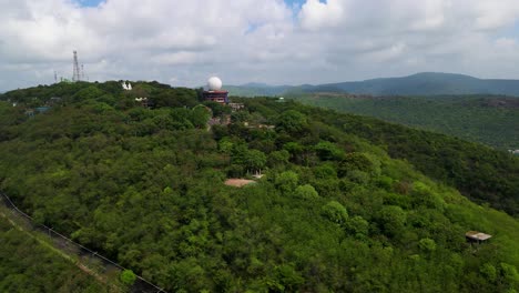 Aerial drone shot capturing the sprawling urban layout of Vizag city, with the ocean stretching along its edge.