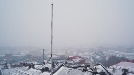 tall pole above snow covered roof in st