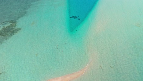 a stunning aerial drone view captures the pristine rasdhoo sandbanks surrounded by crystal-clear turquoise waters in the maldives.