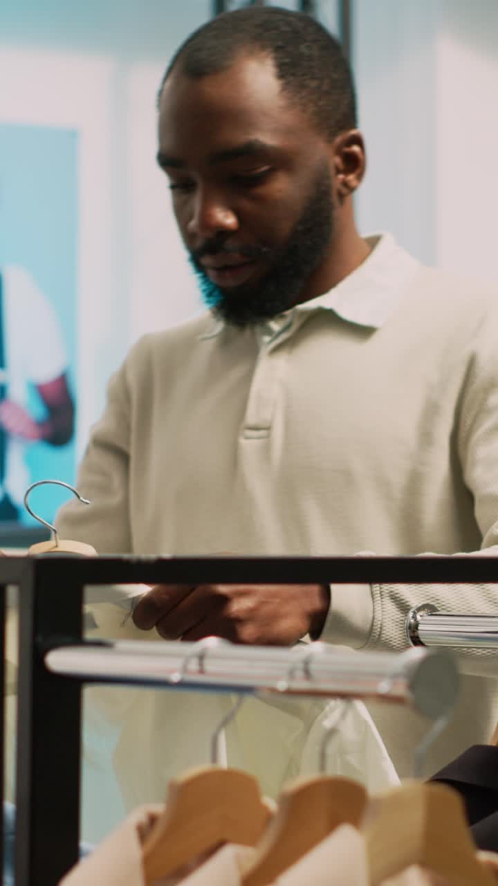 Vertical video: Store manager working on boutique stock with tablet