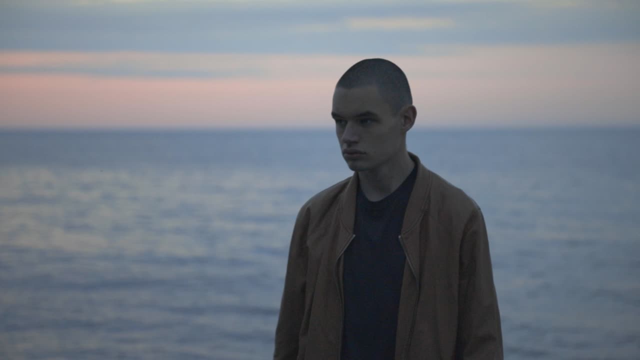 Portrait Of A Man With Sad Face Walking Away From The Shore - Medium Shot (Slow Motion)