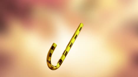 animation of christmas gold candy cane on yellow background