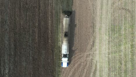 a tanker spreads liquid manure on a wisconsin farm field recently harvested of corn silage