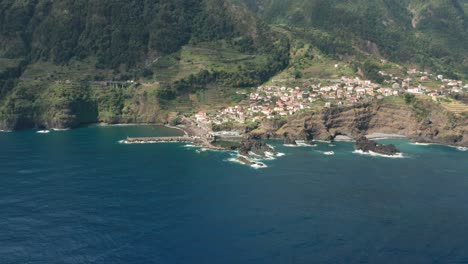 remote island village seixal on steep volcanic shore of madeira, aerial