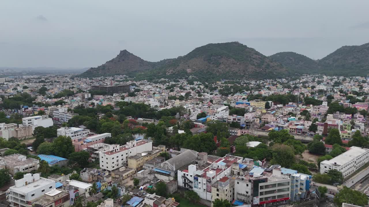Aerial view of a densely populated city with mountains in the background