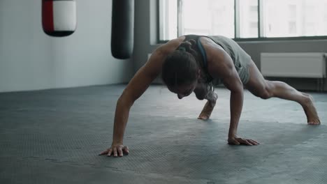 woman doing push-ups in a gym