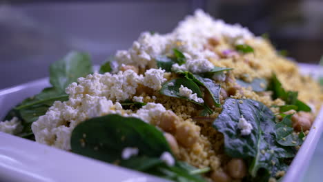 healthy butternut squash salad with beetroot, avocado, walnut and feta cheese in white bowl