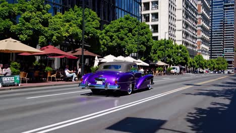 purple vintage convertible in city street