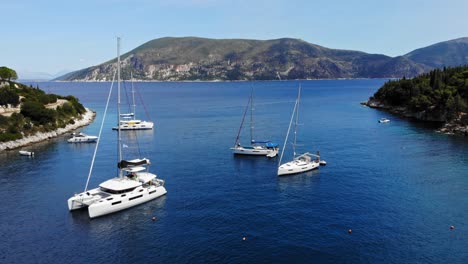 catamaran and sailboats in the ionian sea at the foki beach in the island of kefalonia in greece