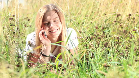 Young-girl-is-talking-on-the-phone-in-city-park