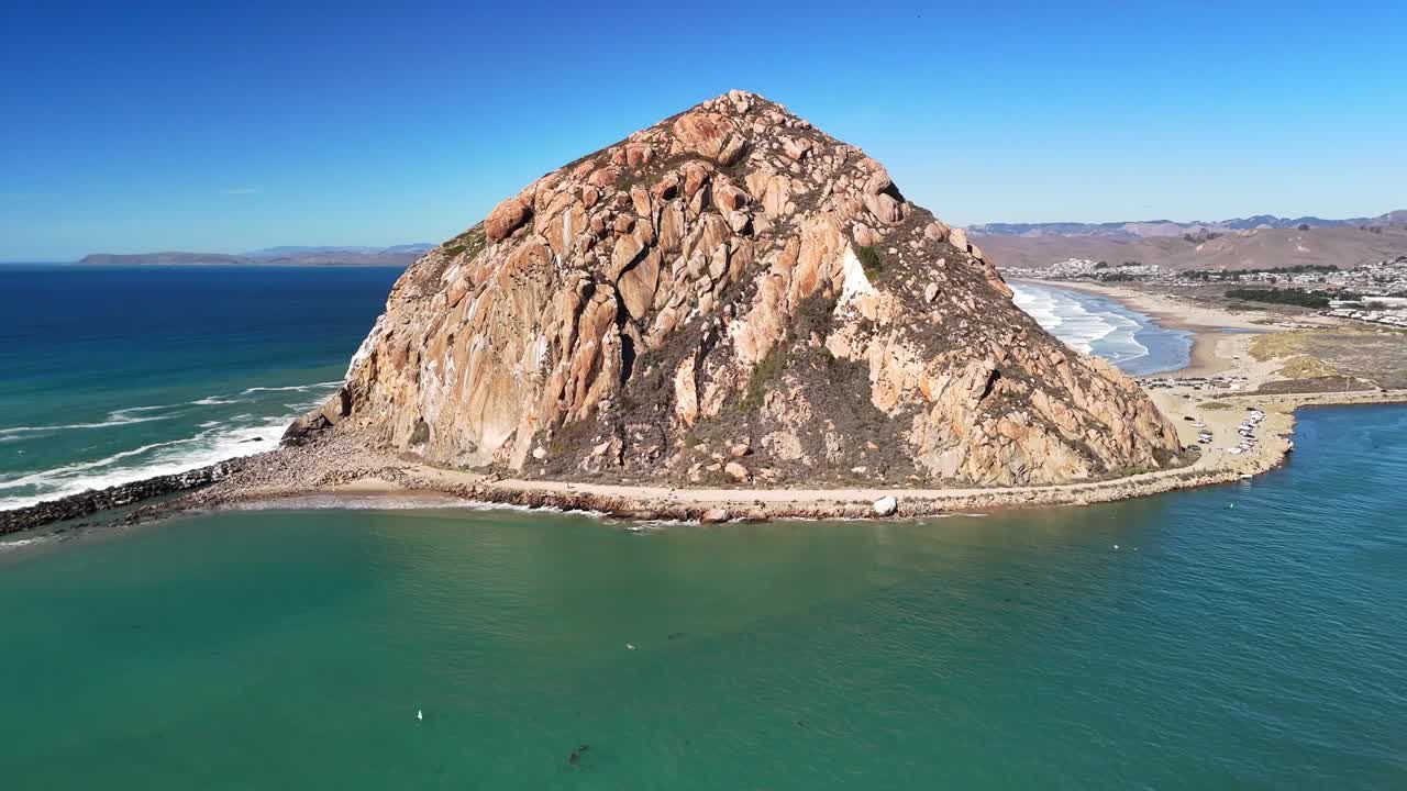 A smooth, wide coastline flyover showing beaches, rolling waves, and the scenic California horizon