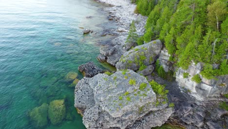 aerial view of the rocky coast with turquoise waters on the shores of georgian bay, ontario, canada