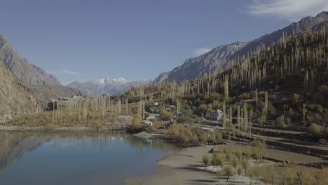 a water body surrounded by mountains is being videoed with a camera