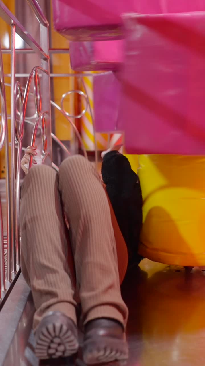 Young woman smiling and relaxing in a vibrant indoor setting