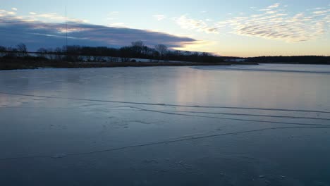 frozen lake and snowy fields at sunrise/sunset