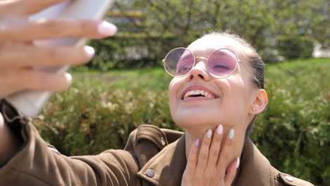 woman taking a selfie in a park