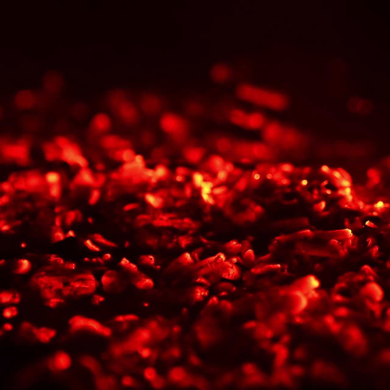 Wood in the campfire burnt out and charcoal is still hot. Red charcoal glowing. Close up