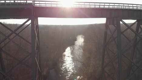 slowly rising above the appomattox river reflecting afternoon sunlight to reveal high bridge trail, a reconstructed civil war railroad bridge