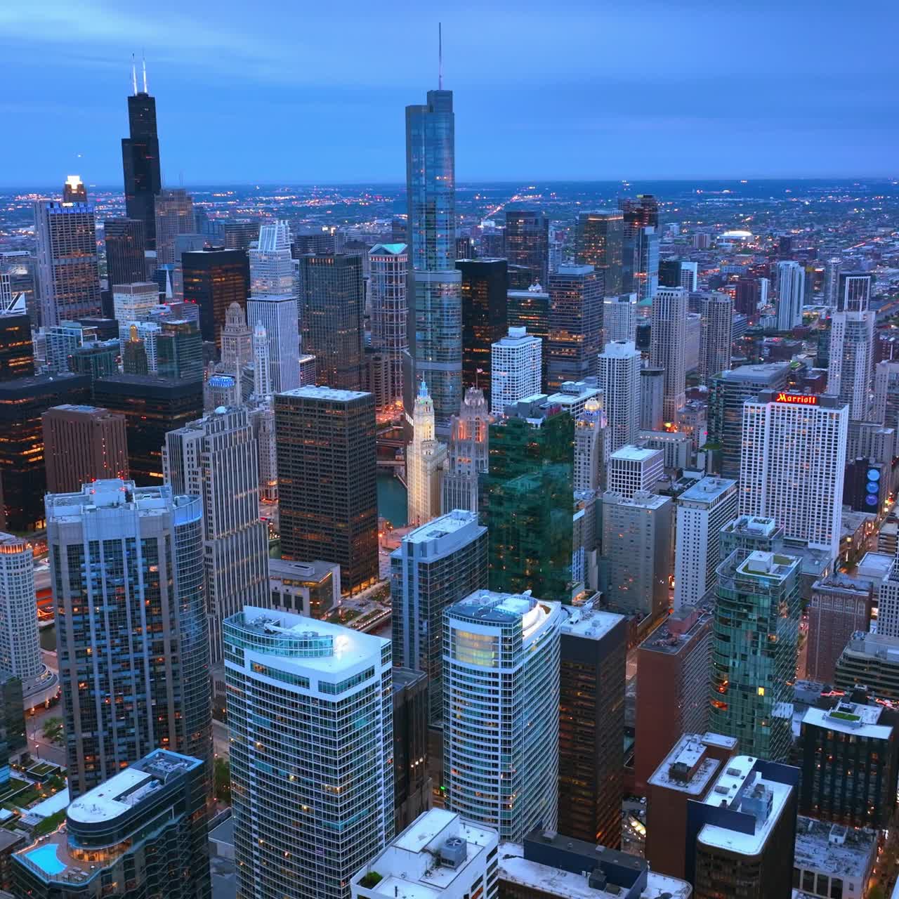 Breath-taking view of marvelous Chicago skyscrapers at dusk time. Amazing city panorama with lights in the evening. Aerial view