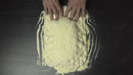 slow motion of baker stretching pizza dough